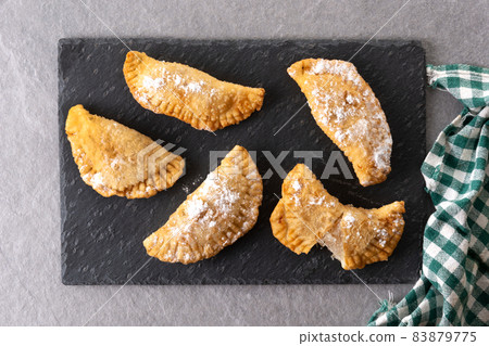 Spanish sweet stuffed pastry filled with angel hair 83879775