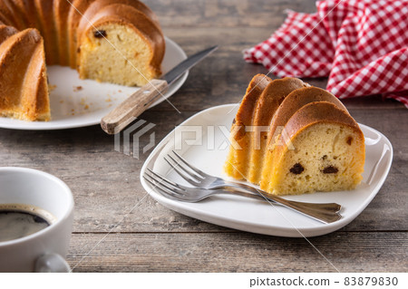 Traditional bundt cake piece with raisins 83879830