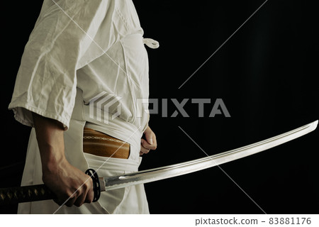 A person holding a Japanese sword 83881176