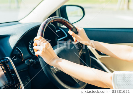 Young woman driving a car 83881631