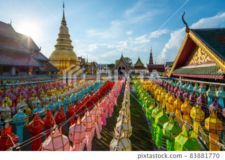 Wat Phra That Hariphunchai with traditional paper lanterns hanging on the rows during Yi peng (or Yee peng) festival in Lamphun province of Thailand. Wat Phra That Hariphunchai with traditional paper lanterns hanging on the rows during Yi peng (or Yee peng) festival in Lamphun province of Thailand. 83881770