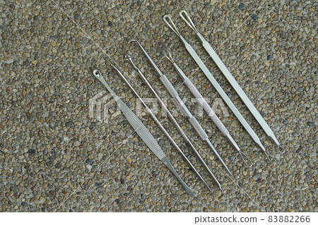 top view steel ear pick kit on stone background, object, copy space 83882266
