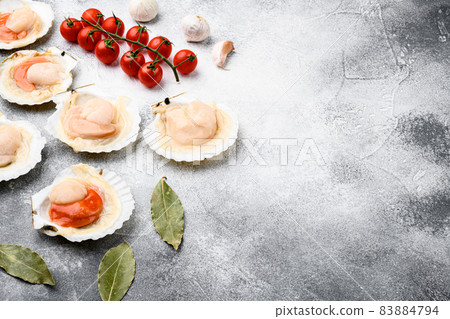 Fresh french scallops seafood market, on gray stone table background, with copy space for text 83884794