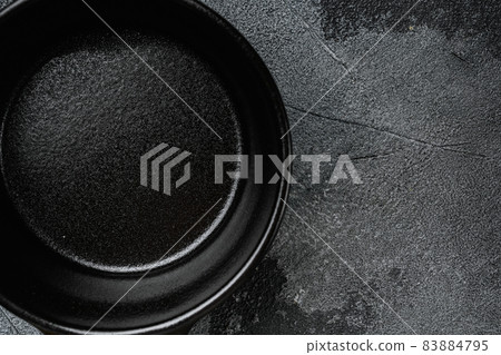 Black cooking pot with copy space for text or food with copy space for text or food, top view flat lay , on gray stone table background 83884795
