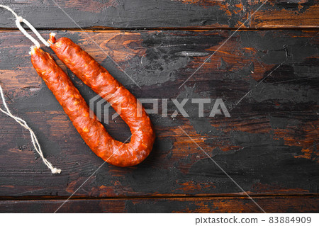 Traditional spanish chorizo sausage on wooden surface with space for text Traditional spanish chorizo sausage on wooden surface with space for text 83884909