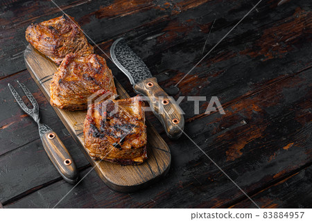 Grilled beef short rib, on old dark wooden table background, with copy space for text Grilled beef short rib, on old dark wooden table background, with copy space for text 83884957