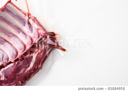 Meat rib in plastic pack set, on white stone table background, top view flat lay, with copy space for text Meat rib in plastic pack set, on white stone table background, top view flat lay, with copy space for text 83884958