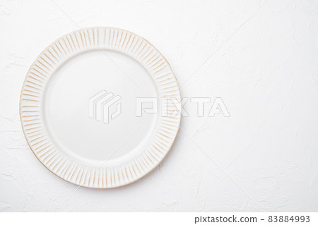Porcelain empty white plate with copy space for text or food with copy space for text or food, top view flat lay , on white stone table background 83884993
