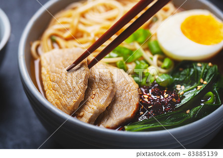 Ramen with pork meat close up shot on a dark background Ramen with pork meat close up shot on a dark background 83885139