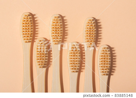 Wooden toothbrushes on brown background, zero waste, top view Wooden toothbrushes on brown background, zero waste, top view 83885148