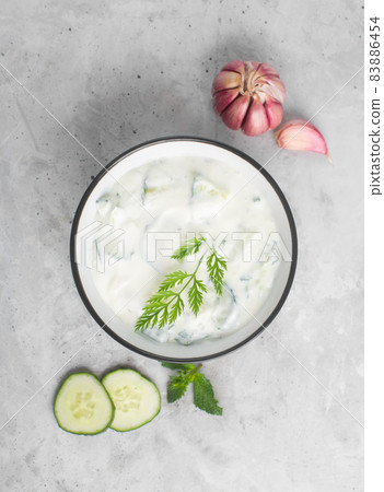 Traditional Indian Raita with Dahi in a bowl, top view 83886454