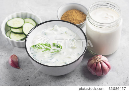 Traditional Indian Raita with Dahi in a bowl with dill 83886457