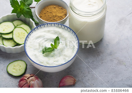 Traditional Indian Raita with Dahi in a bowl, served with mint 83886466