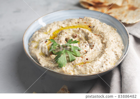Baba ganoush, Ezme in a plate with pita bread on a concrete background Baba ganoush, Ezme in a plate with pita bread on a concrete background 83886482