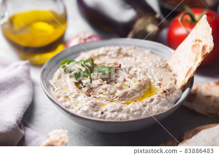Baba ganoush with stuck pita bread poured with olive oil Baba ganoush with stuck pita bread poured with olive oil 83886483
