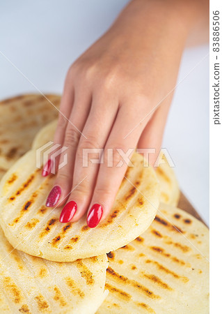 Woman holds Traditional Venezuelan food arepa made from cornmeal 83886506