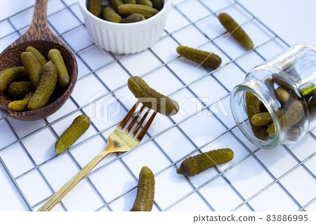 Pickled gherkins or cucumbers on white background. Pickled gherkins or cucumbers on white background. 83886995