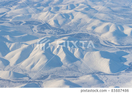 Aerial view of snow-capped mountains 83887486