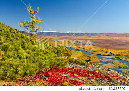 Colorful autumn landscape. Scenic view of the mountains and the vast valley of the river. 83887502