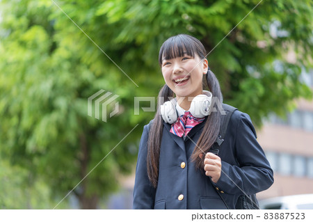 A twin-tailed girl who wears headphones around her neck and goes to school in uniform 83887523