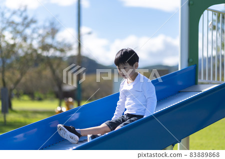 Boy playing on the slide 83889868