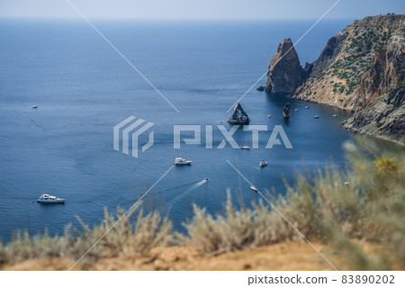 Fiolent , Crimea - sea landscape. Sea view - Mountains surround the bay and the small pleasure yacht boats moored in the lagoon 83890202