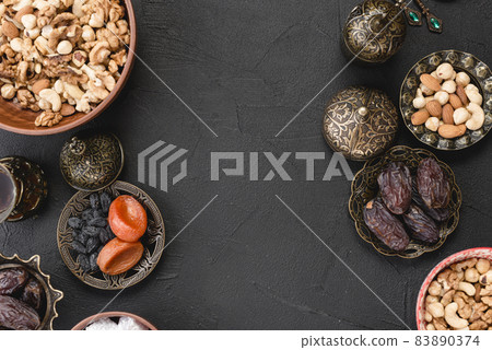 fresh dried fruits nuts dates ramadan black backdrop. High quality beautiful photo concept fresh dried fruits nuts dates ramadan black backdrop. High quality beautiful photo concept 83890374