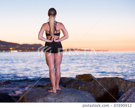 Adult woman is practicing stretching Adult woman is practicing stretching 83890912