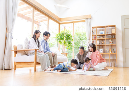 Three-generation family relaxing in the living room 83891218
