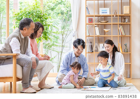 Three-generation family relaxing in the living room Three-generation family relaxing in the living room 83891438
