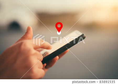 Woman hand using smart phone with navigator location point at street background. Technology interenet and travel adventure concept. 83891535