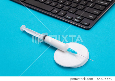 Vaccination or Revaccination Concept - A Medical Syringe on Blue Table 83893369