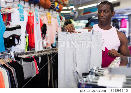 African male customer choosing sportswear African male customer choosing sportswear 83894340
