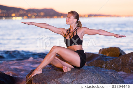 Adult woman is practicing stretching Adult woman is practicing stretching 83894446