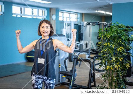 Sports trainer working at a sports gym (guts pose) Sports trainer working at a sports gym (guts pose) 83894933