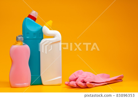 House cleaning detergent bottles on a yellow background House cleaning detergent bottles on a yellow background 83896353