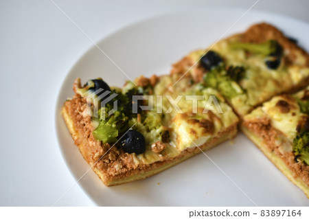 Meat pizza with greens on a white plate 83897164