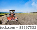 Plowing rice fields with a tractor 83897532