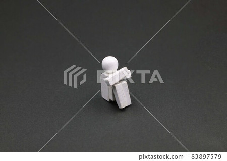 Image of a person who is depressed and holding his knees Image of a person who is depressed and holding his knees 83897579