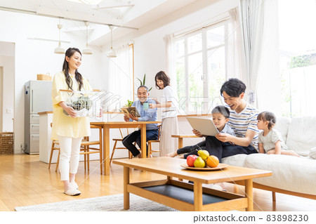 Three-generation family relaxing in the living room Three-generation family relaxing in the living room 83898230