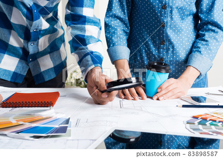 Man carefully studying technical drawing Man carefully studying technical drawing 83898587
