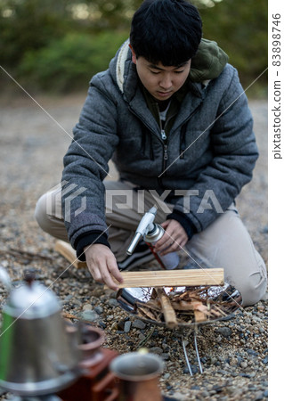 Preparing for a bonfire at a solo camp Preparing for a bonfire at a solo camp 83898746