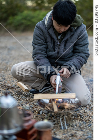 Preparing for a bonfire at a solo camp Preparing for a bonfire at a solo camp 83898748