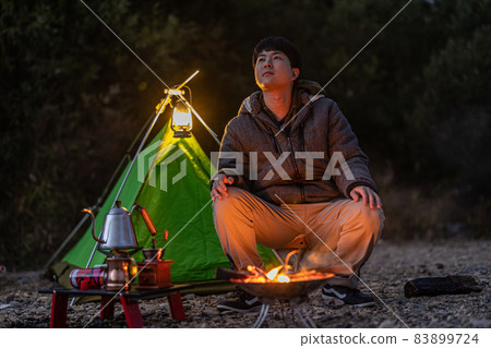 Enjoy a bonfire at a solo camp 83899724