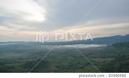 slow floating fog blowing cover on the top of mountain look like as a sea of mist. In the morning the cold weather is make floating fog on the mountain as a sea of mist white cloud in blue sky over slow floating fog blowing cover on the top of mountain look like as a sea of mist. In the morning the cold weather is make floating fog on the mountain as a sea of mist white cloud in blue sky over 83900488