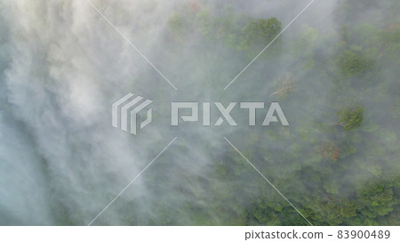 slow floating fog blowing cover on the top of mountain look like as a sea of mist. In the morning the cold weather is make floating fog on the mountain as a sea of mist white cloud in blue sky over slow floating fog blowing cover on the top of mountain look like as a sea of mist. In the morning the cold weather is make floating fog on the mountain as a sea of mist white cloud in blue sky over 83900489