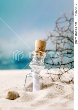 Summer sand sea beach with waves and glass botle with message 83902007