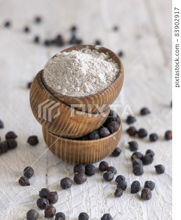 Wooden bowls of black chickpea flour and beans closeup Wooden bowls of black chickpea flour and beans closeup 83902917