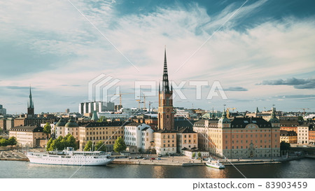 Stockholm, Sweden. Gamla Stan Is Famous Popular Place And Destination Scenic. Riddarholm Church In Sunny Summer Cityscape Skyline. Scenic View Of Embankment In Old Town. UNESCO World Heritage Site. Stockholm, Sweden. Gamla Stan Is Famous Popular Place And Destination Scenic. Riddarholm Church In Sunny Summer Cityscape Skyline. Scenic View Of Embankment In Old Town. UNESCO World Heritage Site. 83903459