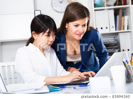 Two businesswomen working with computer in office 83904160